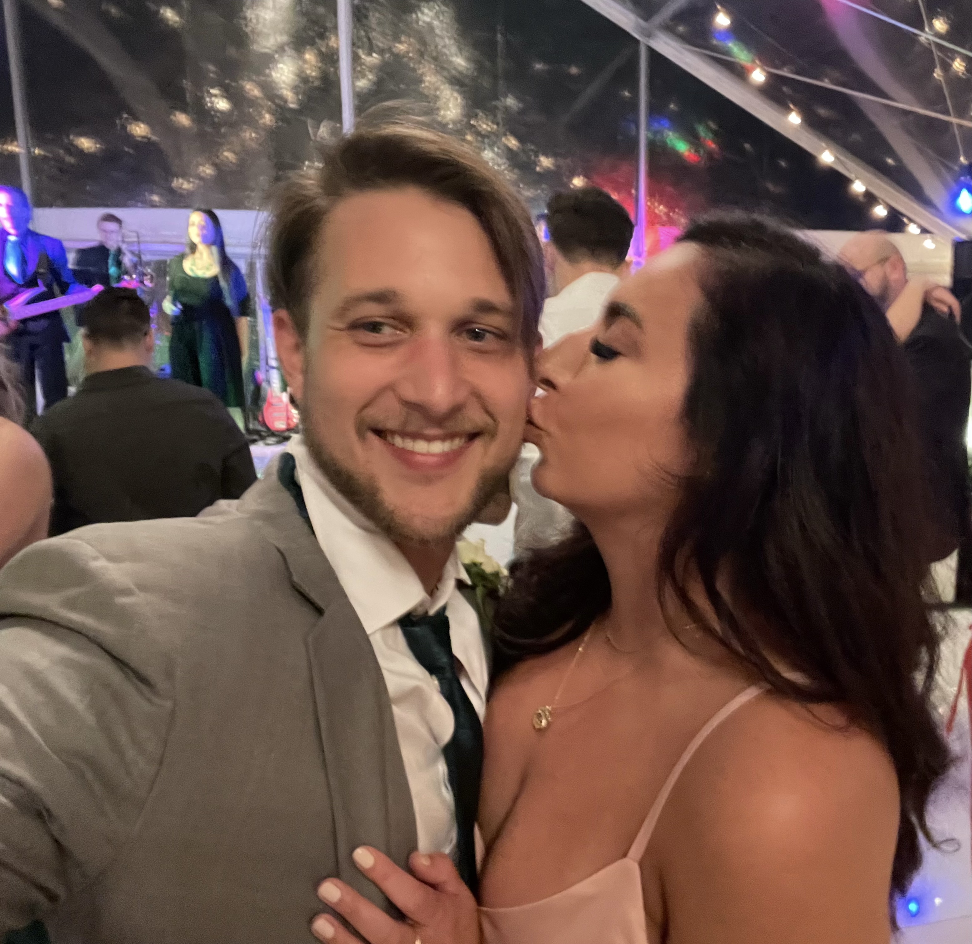 Cristina kissing Peter at a wedding