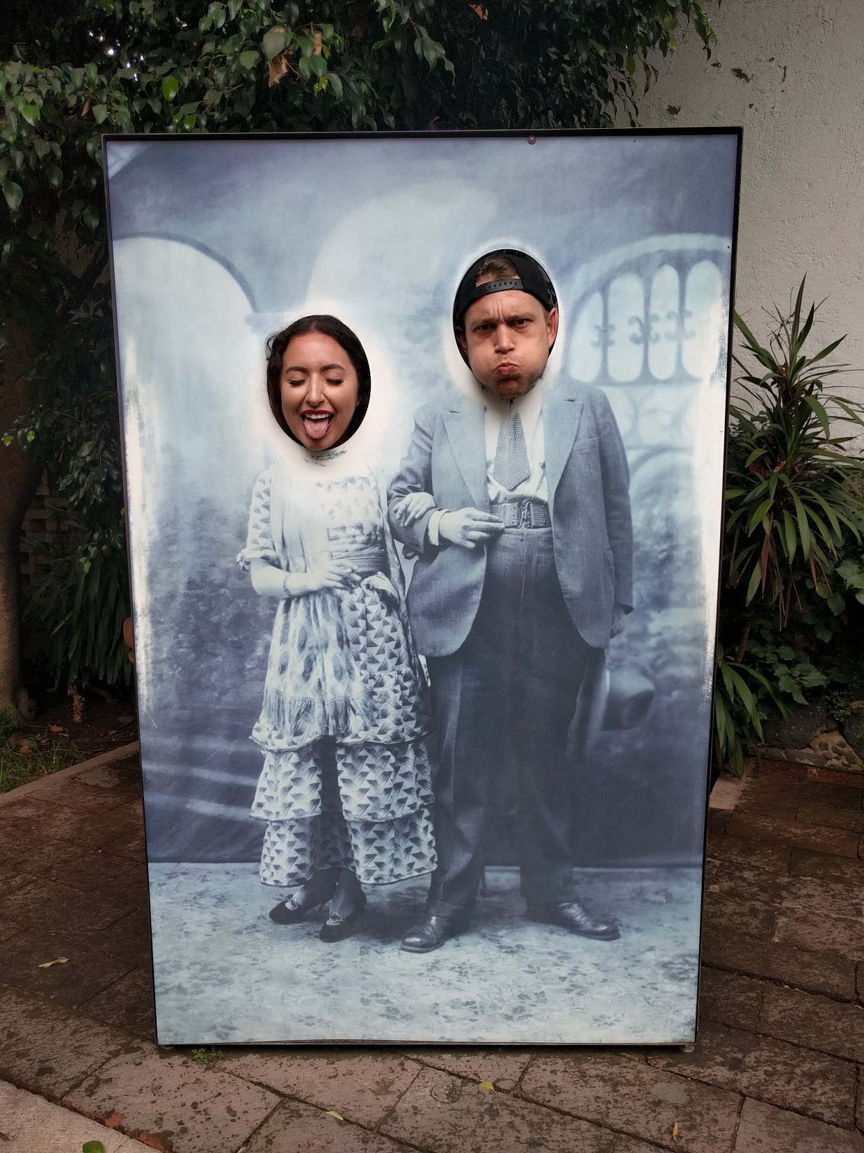 Peter and Cristina making silly faces in a photo board